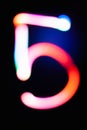 Digit 5. Five. Glowing numbers on dark background. Abstract light painting at night. Creative artistic colorful bokeh. New Year. Royalty Free Stock Photo