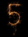 Digit 5 or five made of bengal fire, sparkler fireworks candle isolated on a black background Royalty Free Stock Photo