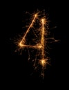 Digit 4 or four made of bengal fire, sparkler fireworks candle isolated on a black background Royalty Free Stock Photo