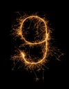 Digit 9 or nine made of bengal fire, sparkler fireworks candle isolated on a black background Royalty Free Stock Photo