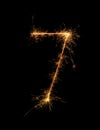 Digit 7 or seven made of bengal fire, sparkler fireworks candle isolated on a black background Royalty Free Stock Photo