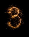 Digit 3 or three made of bengal fire, sparkler fireworks candle isolated on a black background Royalty Free Stock Photo