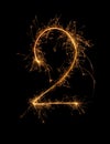 Digit 2 or two made of bengal fire, sparkler fireworks candle isolated on a black background Royalty Free Stock Photo