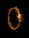 Digit 0 or zero made of bengal fire, sparkler fireworks candle isolated on a black background Royalty Free Stock Photo