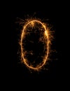 Digit 0 or zero made of bengal fire, sparkler fireworks candle isolated on a black background Royalty Free Stock Photo