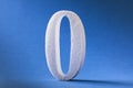 The digit is zero made of foam on a blue background. Concept on zeroing Royalty Free Stock Photo