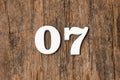 Digit zero seven - White numbers on rustic wooden background