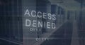 Digital ACCESS DENIED overlay hovering in data center corridor, with server racks and binary code Royalty Free Stock Photo