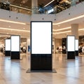 Digital advertising displays in a modern shopping mall setting. The screens are Royalty Free Stock Photo