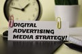 Digital Advertising Media Strategy! on the paper isolated on it desk. Business and inspiration concept