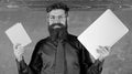 Digital against paper. Teacher bearded hipster holds book and laptop. What would you prefer. Teacher choosing modern