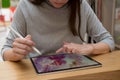A digital artist draws on a graphic screen tablet, modern technologies for creativity.
