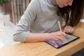 A digital artist draws on a graphic screen tablet using a stylus, a freelancer works in a public space coworking