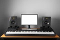 Digital audio workstation studio with electronic piano and monitor speakers