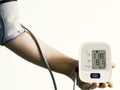 Digital blood pressure monitor with arm blood pressure measurement and white background Royalty Free Stock Photo