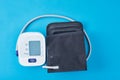 Digital blood pressure monitor on a blue background, closeup. Helathcare and medical concept