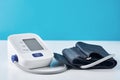 Digital blood pressure monitor on a blue background, closeup. Helathcare and medical concept