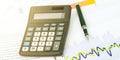 Digital calculator with colored keys fountain pen on table Royalty Free Stock Photo