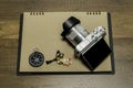 Digital Camera on Brown paper with compass and fish necklace Royalty Free Stock Photo