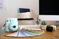 Camera and color palette on table in studio. Modern designer`s workplace Royalty Free Stock Photo