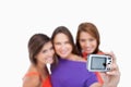 Digital camera photographing three teenagers Royalty Free Stock Photo