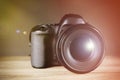 Digital camera of professional photographer on wooden table Royalty Free Stock Photo