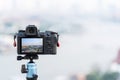 Digital camera put on the tripod for shoot something with landscape of bangkok in display or live view Royalty Free Stock Photo
