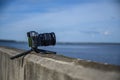 Digital camera stand on small tripod photographing sea, Blue sky and cloud landscape. nature background