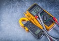 Digital clamp meter electric tester multimeter on metallic backg Royalty Free Stock Photo