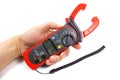 Digital clamp multimeter in man`s hand on a white background Royalty Free Stock Photo