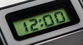 A digital clock displaying the time as 12:00 with a bright green Royalty Free Stock Photo
