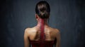 Digital composite of back of asian woman with highlighted spine against grey wall Royalty Free Stock Photo