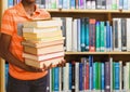 Boy holding books in education library Royalty Free Stock Photo