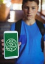 Boy holding a phone with school icons on screen Royalty Free Stock Photo