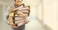 Business man holding folders against yellow blurred background Royalty Free Stock Photo