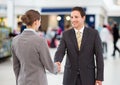 business woman and man handshake. shopping centre