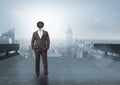 Businessman with CCTV head with city skyline