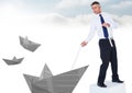 Businessman with paper boats and rope in sky Royalty Free Stock Photo