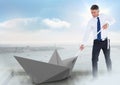 Businessman pulling paper boat with rope in city sky Royalty Free Stock Photo