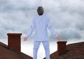 Businessman standing on Roofs with chimney and cloudy sky Royalty Free Stock Photo