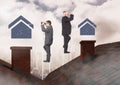 Businessmen on property ladder looking at house icons over roof Royalty Free Stock Photo