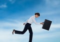 Businesswoman running with briefcase in the sky Royalty Free Stock Photo