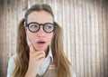 Close up of nerd woman thinking against blurry wood panel