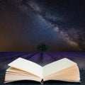 Digital composite concept image of open book wth Vibrant Milky Way composite image over landscape of Beautiful lavender field Royalty Free Stock Photo