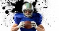 Digital composite of confident american football player holding ball against splattered background