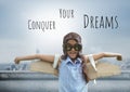 Conquer your dreams text and Pilot girl with wings over city background