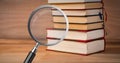 3D Magnifying glass over books Royalty Free Stock Photo