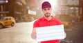 Delivery man with pizza boxes against blurry street with flare Royalty Free Stock Photo