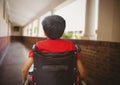 Disabled boy in wheelchair in school corridor Royalty Free Stock Photo