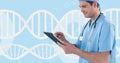 Doctor man using a tablet with 3D DNA strand Royalty Free Stock Photo